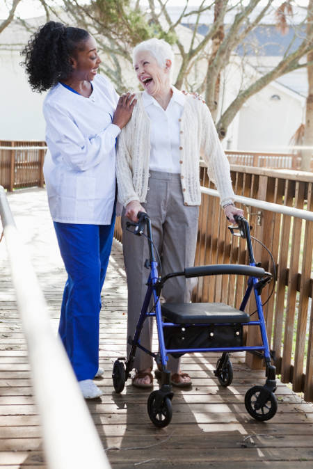 woman with walker and caregiver